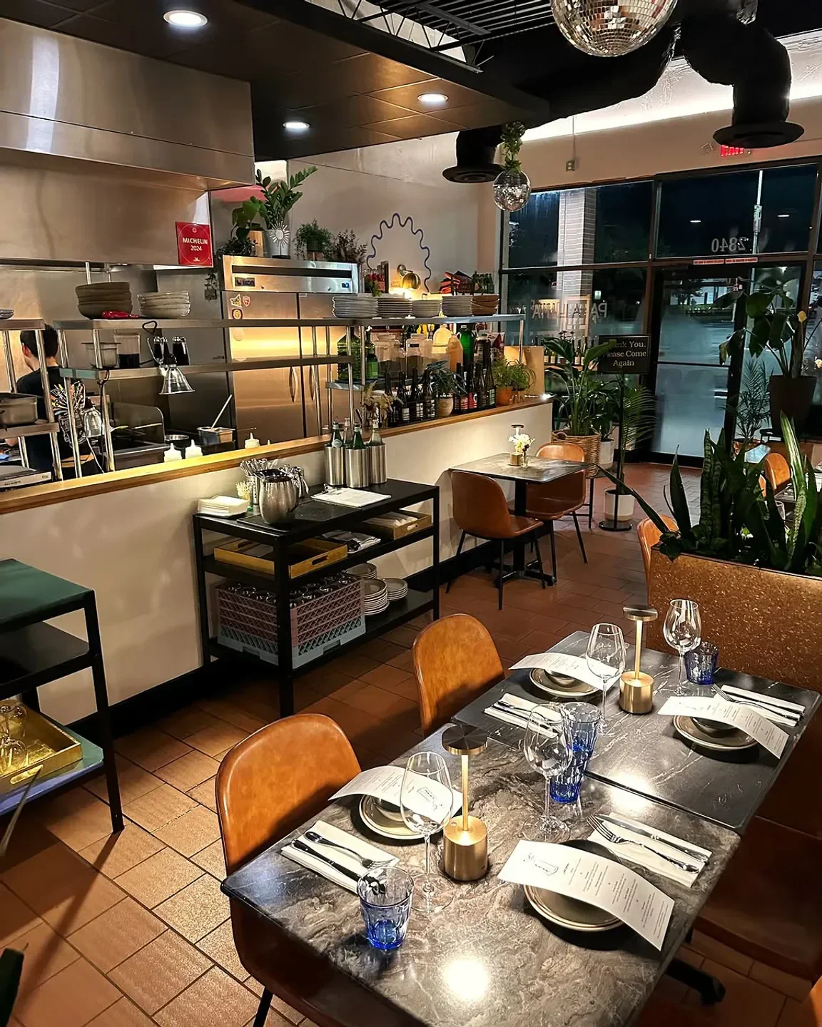 Cozy dining area at Papa Llama restaurant in Orlando, with a glimpse of the kitchen.