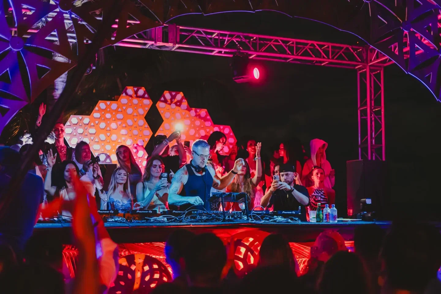 DJ at Papaya Playa Project nightclub in Tulum, Mexico, with a lively crowd.