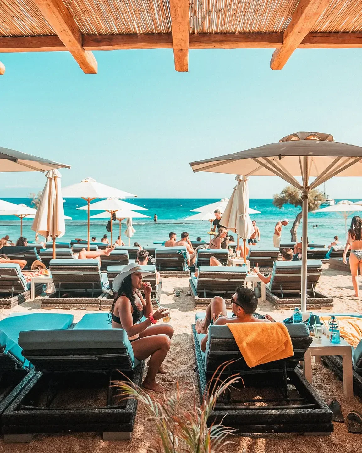 Paradise Beach Club in Mykonos: relaxing beach scene with sunbeds and ocean views