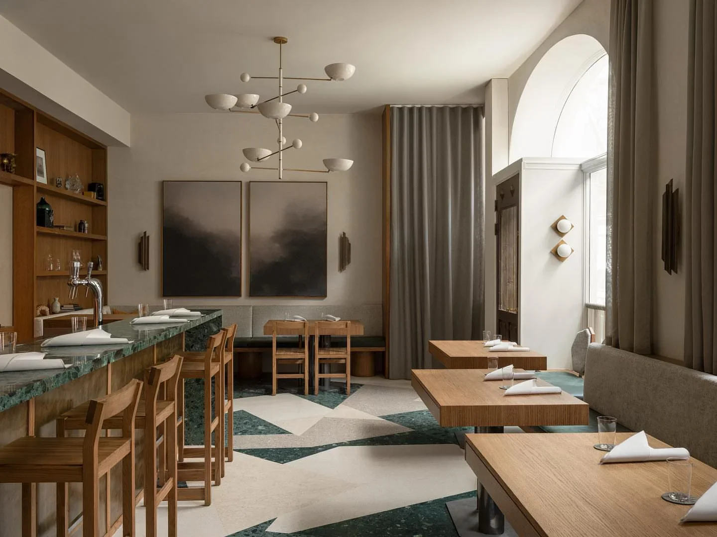 Modern dining room interior at Persona restaurant in the city, featuring a green marble bar and abstract art.