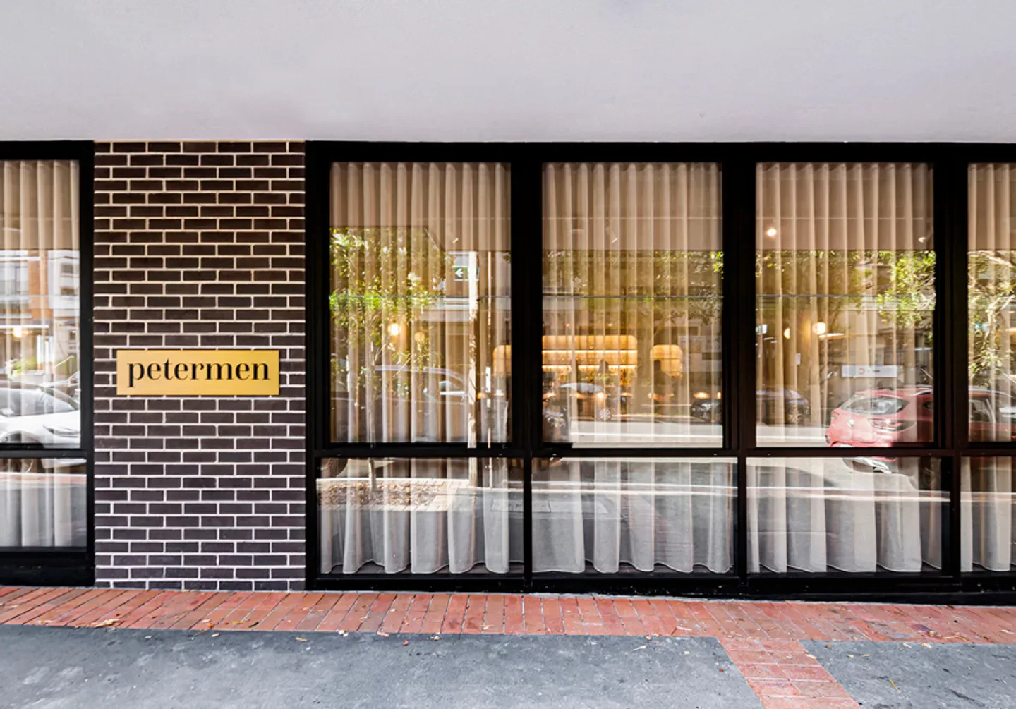 Petermen restaurant in Sydney, exterior view with elegant windows and sign.