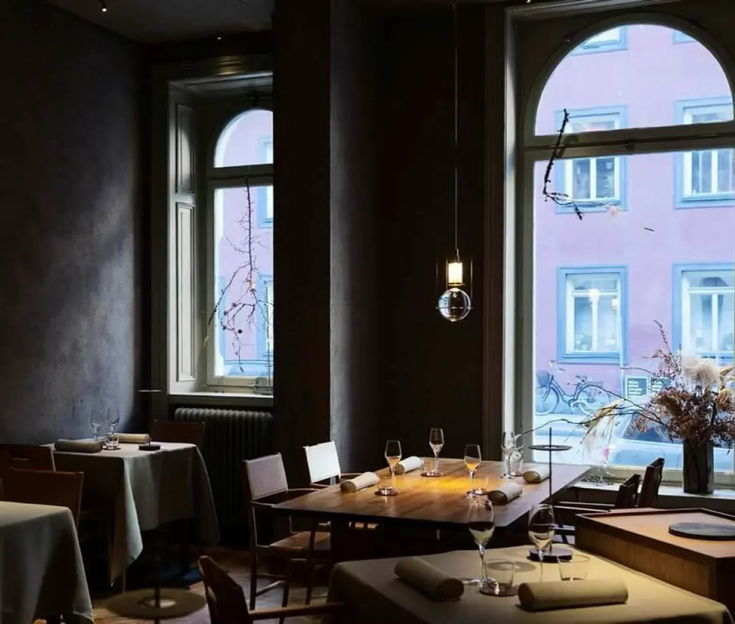 Cozy dining room at PETRI in Stockholm, featuring elegant table settings and city views.