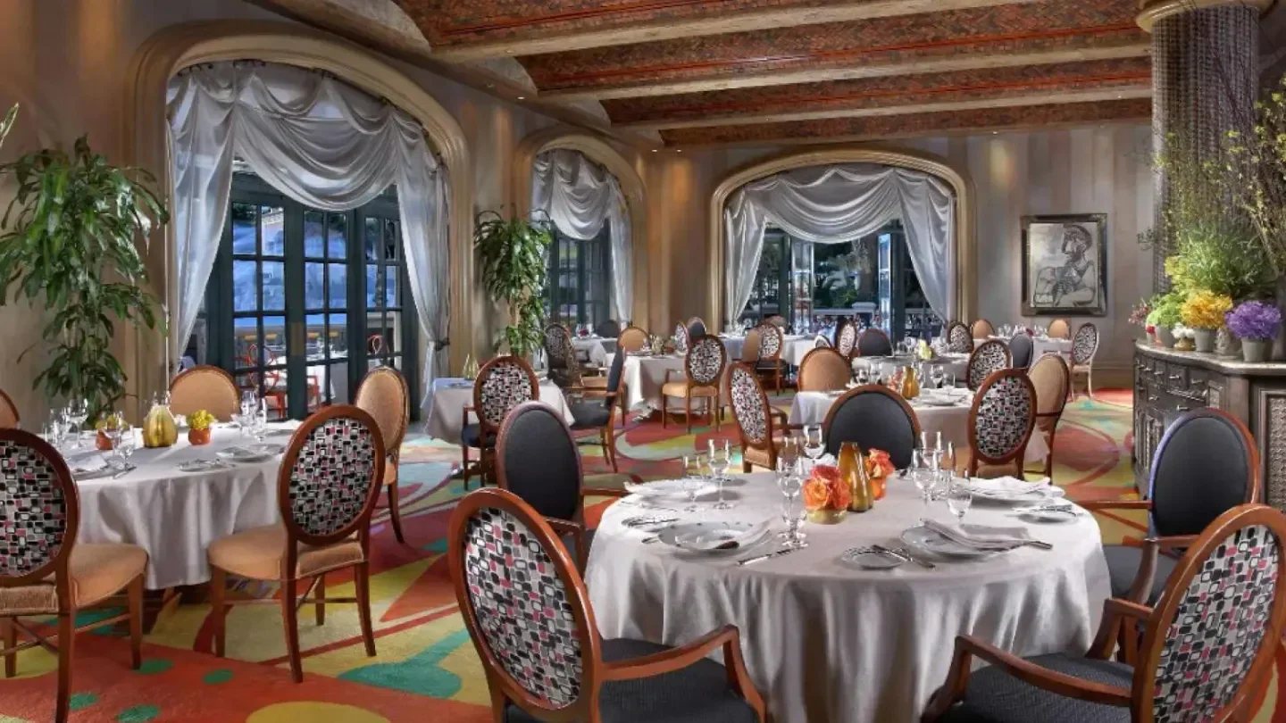 Elegant dining room interior at Picasso in Las Vegas, with tables set for service.