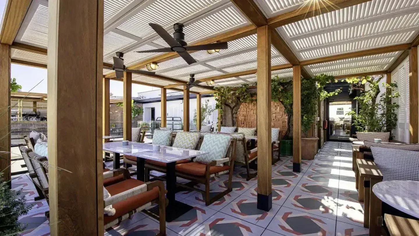 Outdoor dining area at Picos Pardos Sky Lounge in Madrid, with stylish decor.