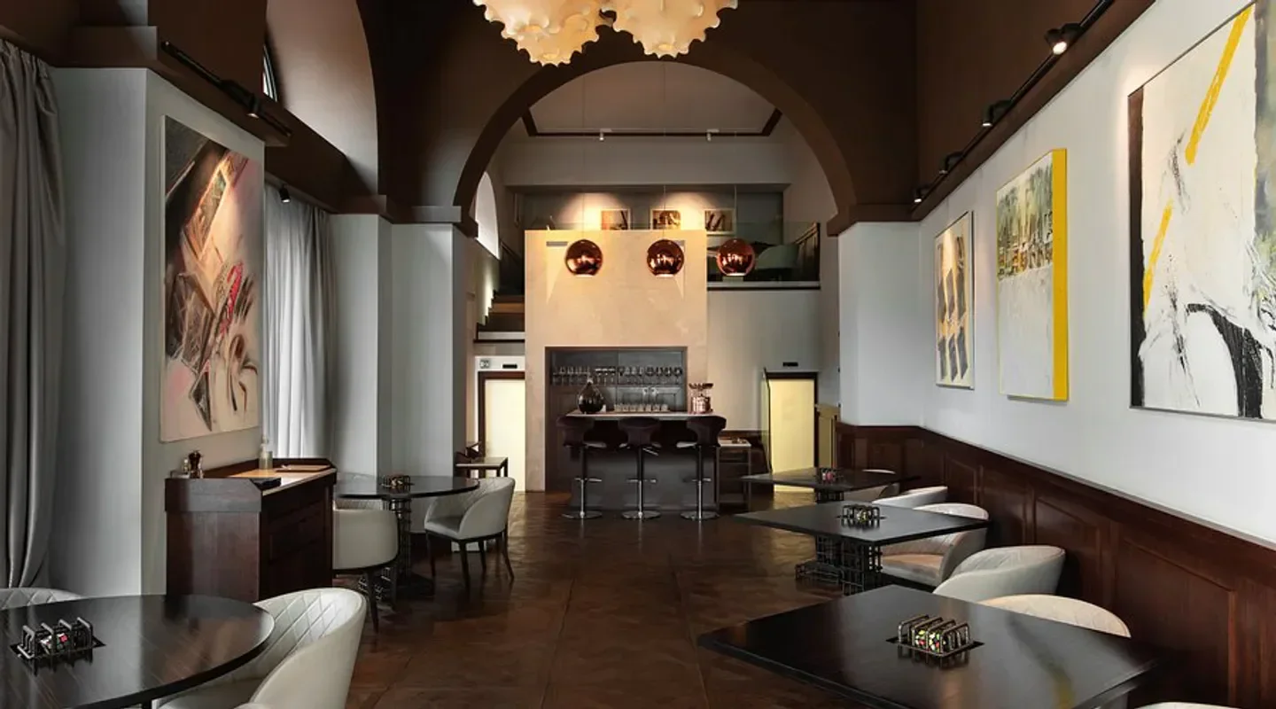 Elegant interior of Pipero restaurant in Rome, featuring art and stylish decor.