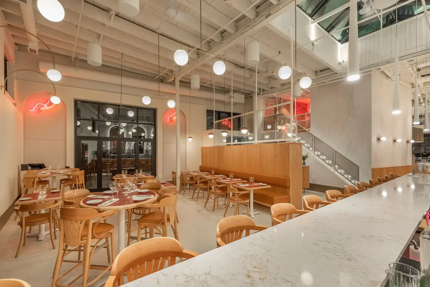 Interior of Place Carmin restaurant in Montreal featuring stylish design and lighting.