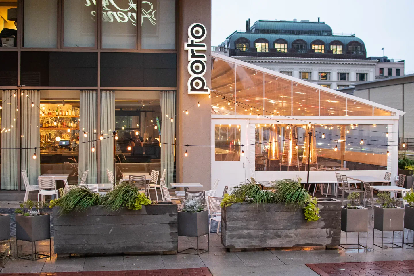 Outdoor patio at Porto restaurant in Boston, with string lights and heaters.