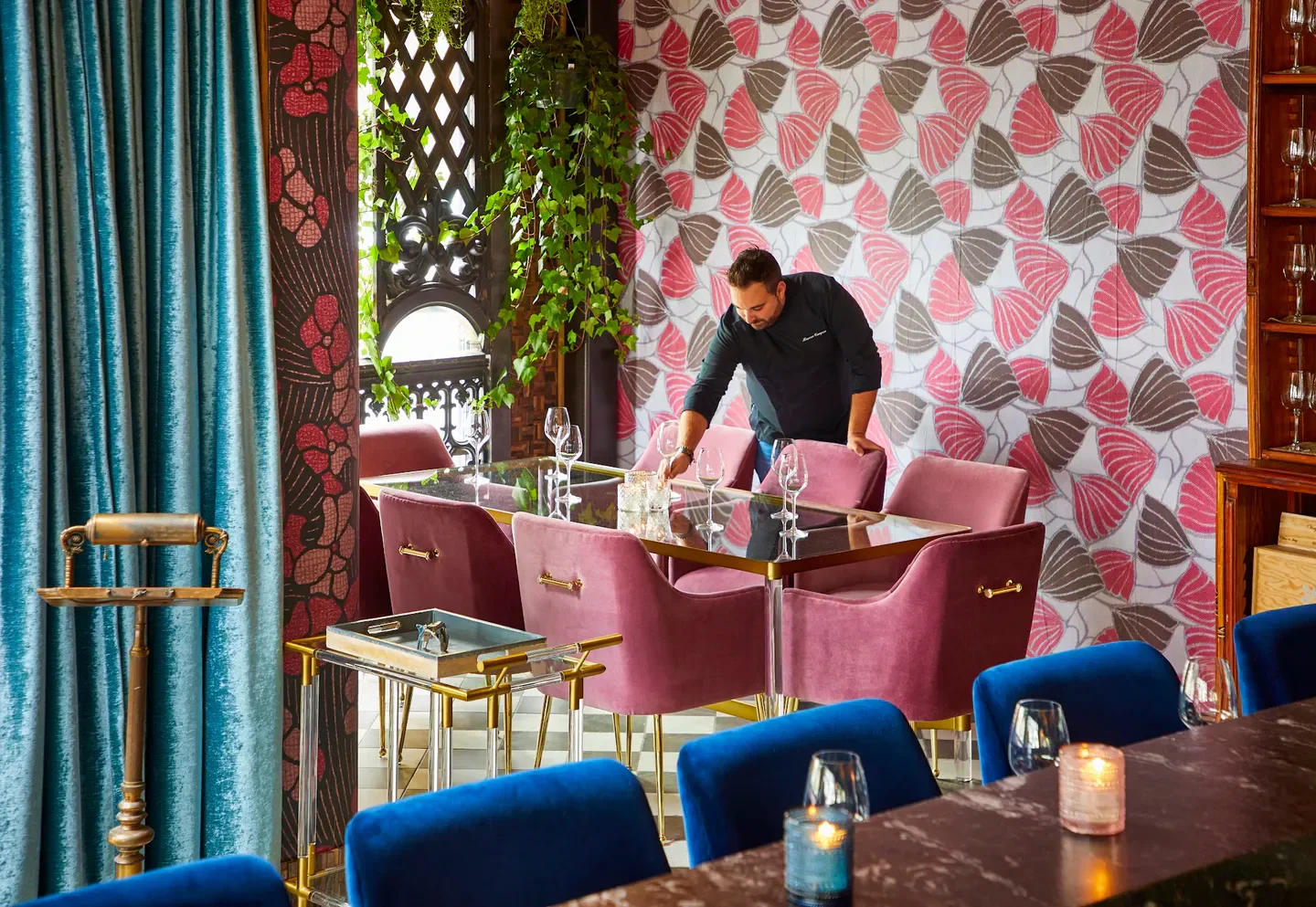 Elegant dining area at Porto restaurant in Chicago, with staff preparing tables.