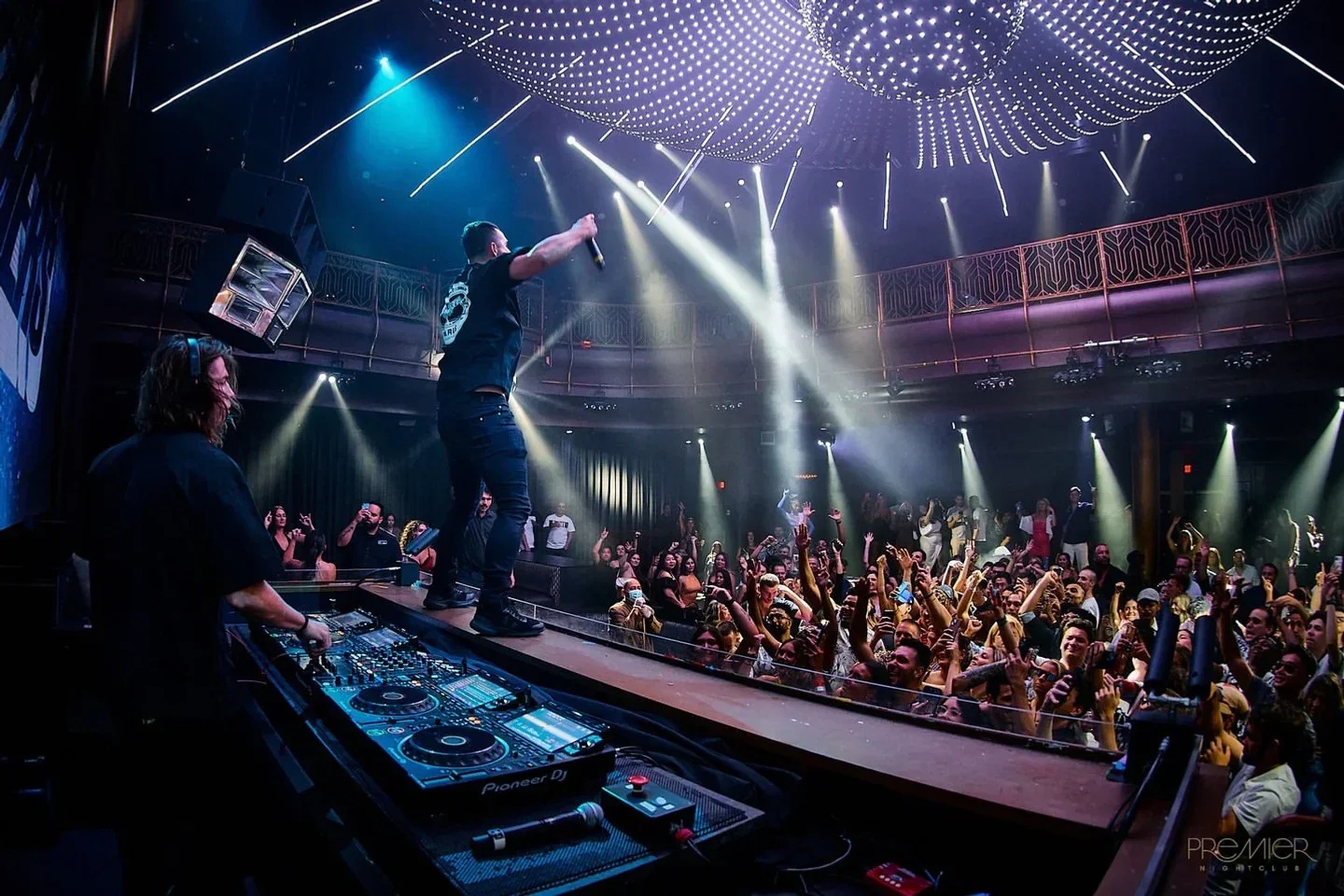 Premier Nightclub in Atlantic City, DJ performing with a crowd of people partying.