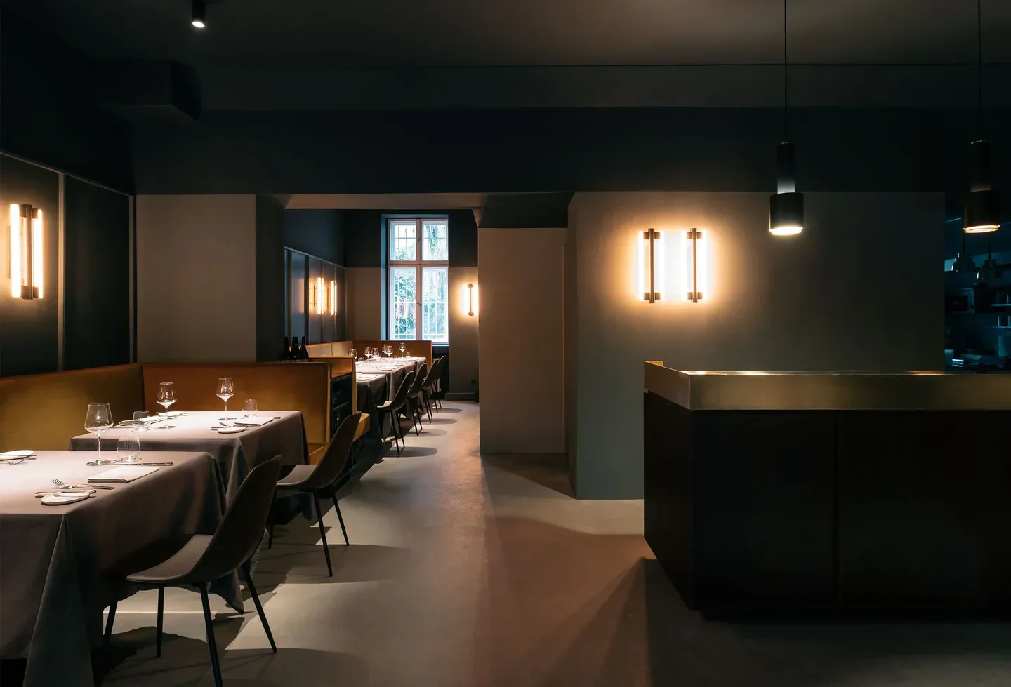 Elegant dining room interior at Prism restaurant in Berlin, featuring stylish decor and lighting.