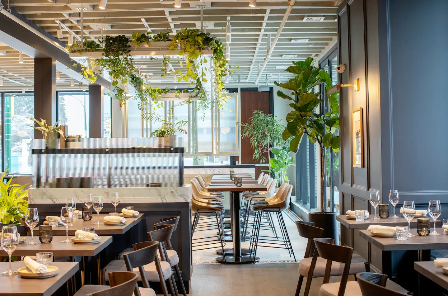 Interior of Published on Main restaurant in Vancouver, with stylish decor and plants.