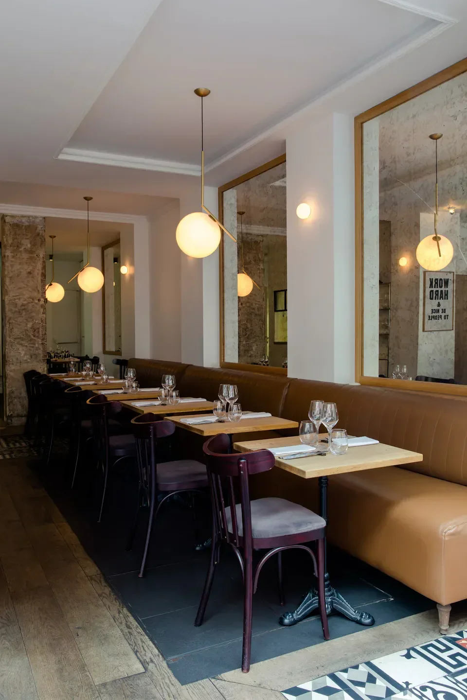 Interior of Quinsou restaurant in Paris, featuring elegant seating and lighting.