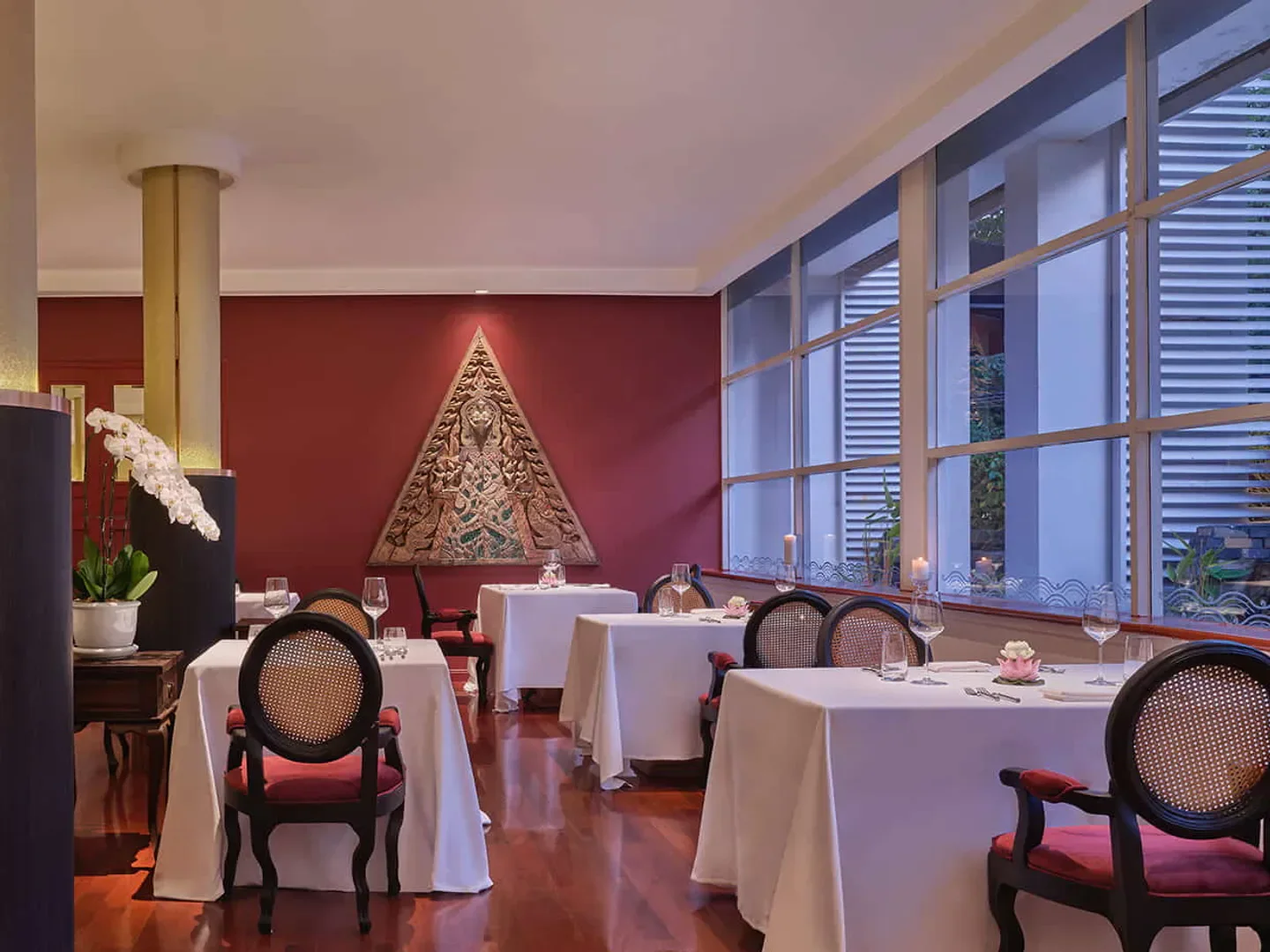 Elegant dining room interior at R-Haan restaurant in Bangkok, featuring fine dining tables