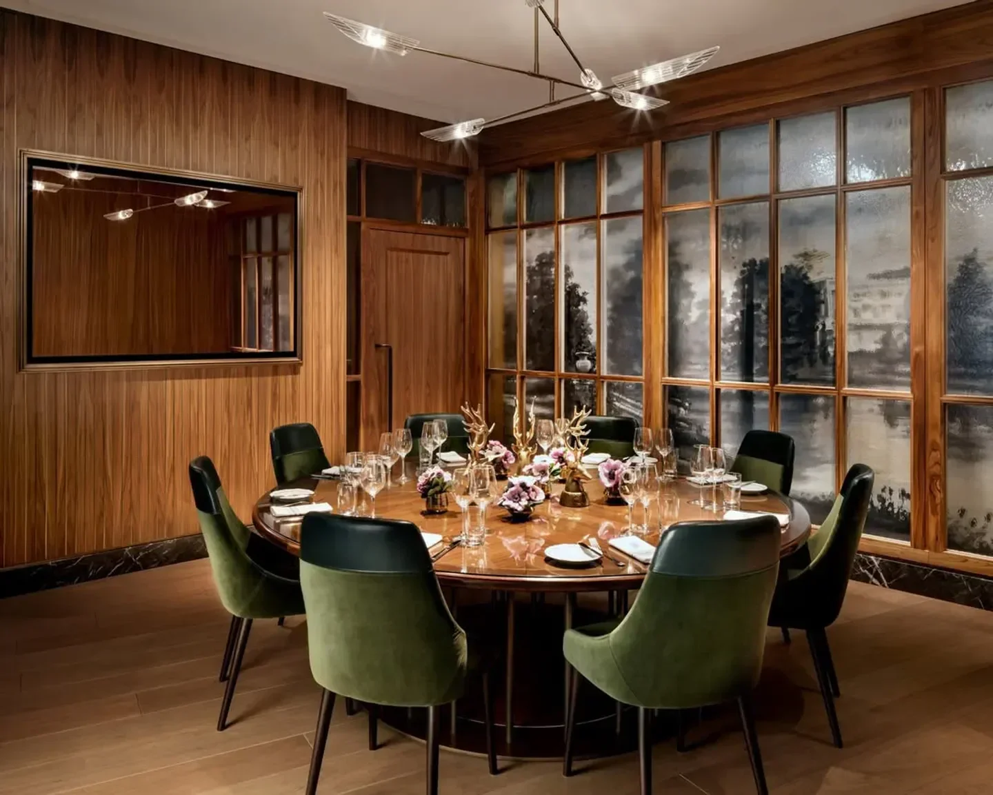 Elegant dining room at Reign restaurant in Toronto, featuring a round table setting.