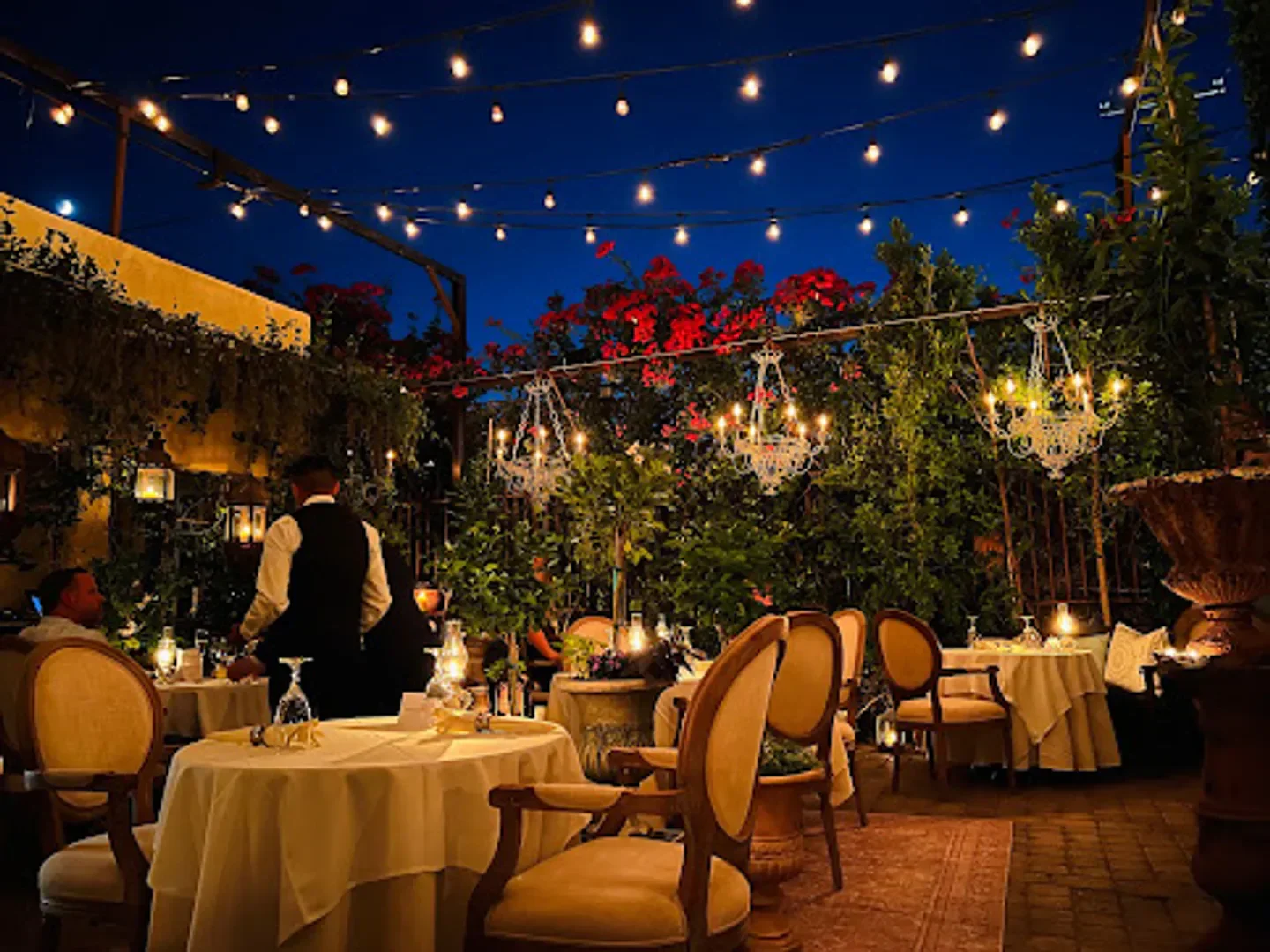 Reserve restaurant in Scottsdale, outdoor dining with chandeliers and string lights at night
