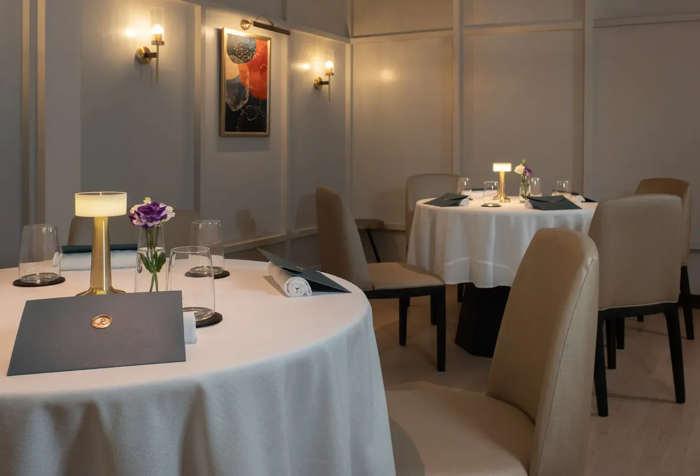 Elegant dining room interior at Resonance, Bangkok, with tables set for a fine dining experience.