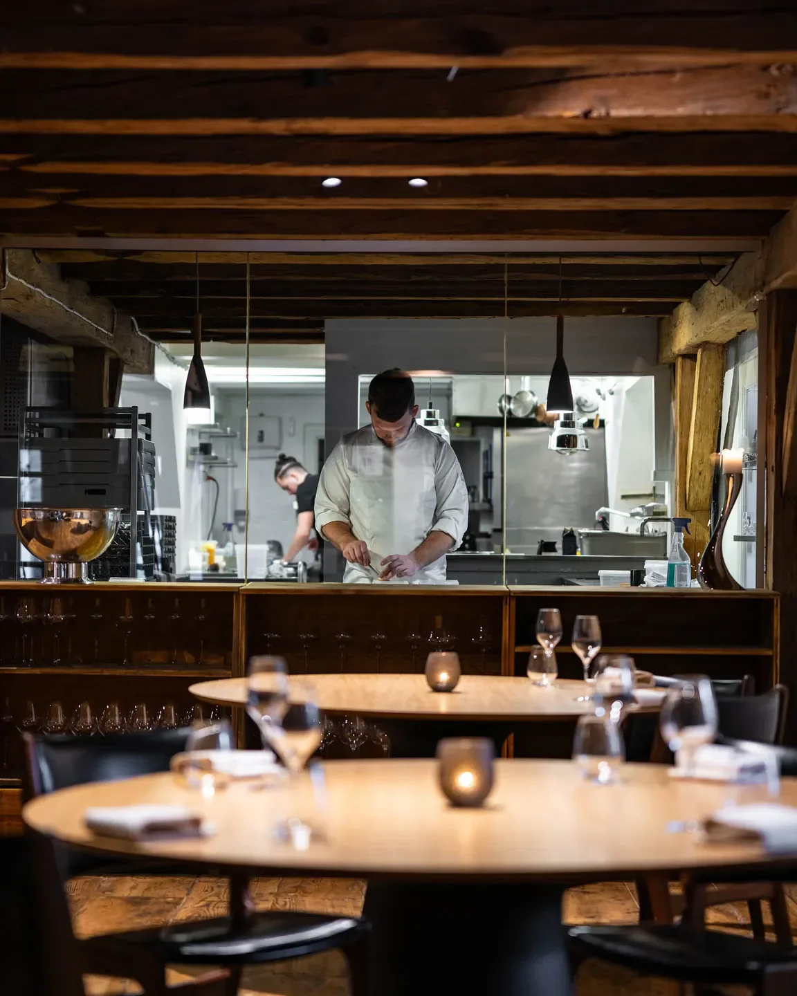 Chef at work in Restaurant Aure, Copenhagen, preparing food for dining experience.