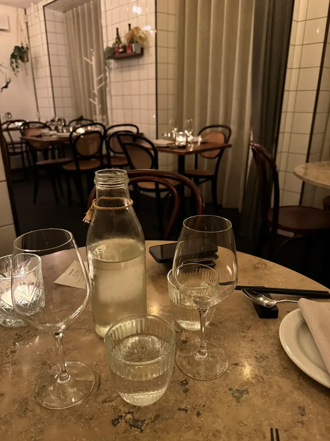 Table setting at Restaurant Juju in Copenhagen with water glasses and elegant decor.