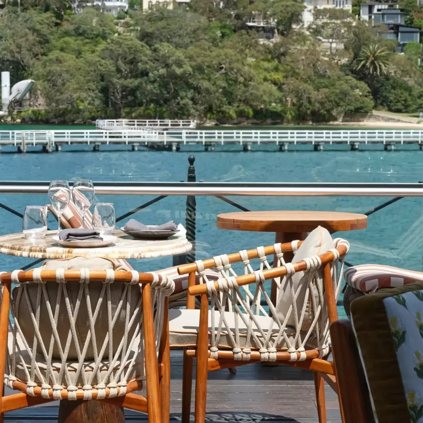 Outdoor dining at Ripples Chowder Bay in Sydney with waterfront views and stylish chairs.