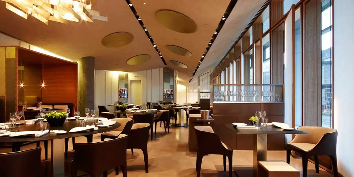 Elegant interior of Ristorante Berton in Milan, showcasing modern design and fine dining setting.