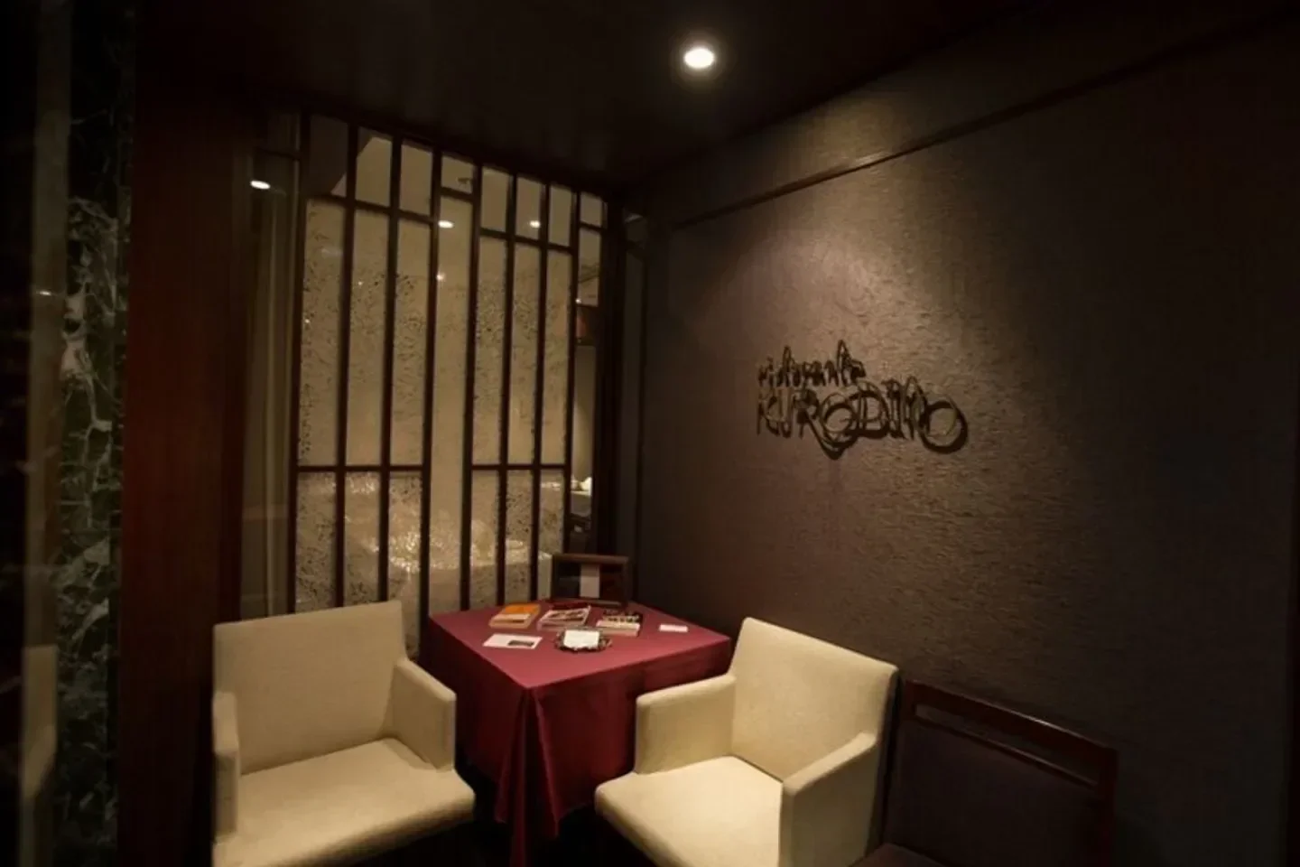 Cozy seating area at Ristorante KURODINO in Tokyo, featuring stylish interior design.