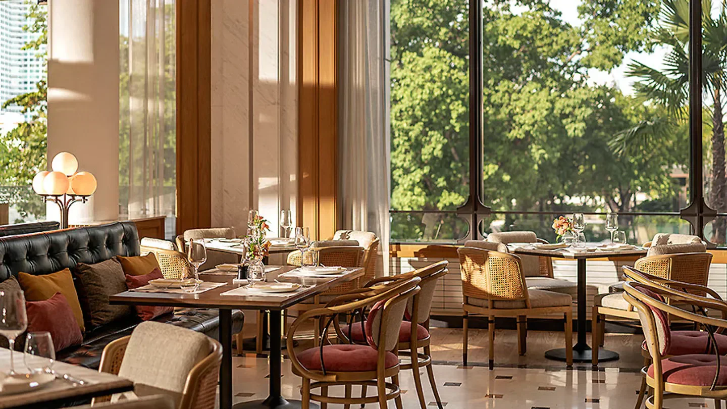Elegant dining at Riva Del Fiume restaurant in Bangkok with natural light and views