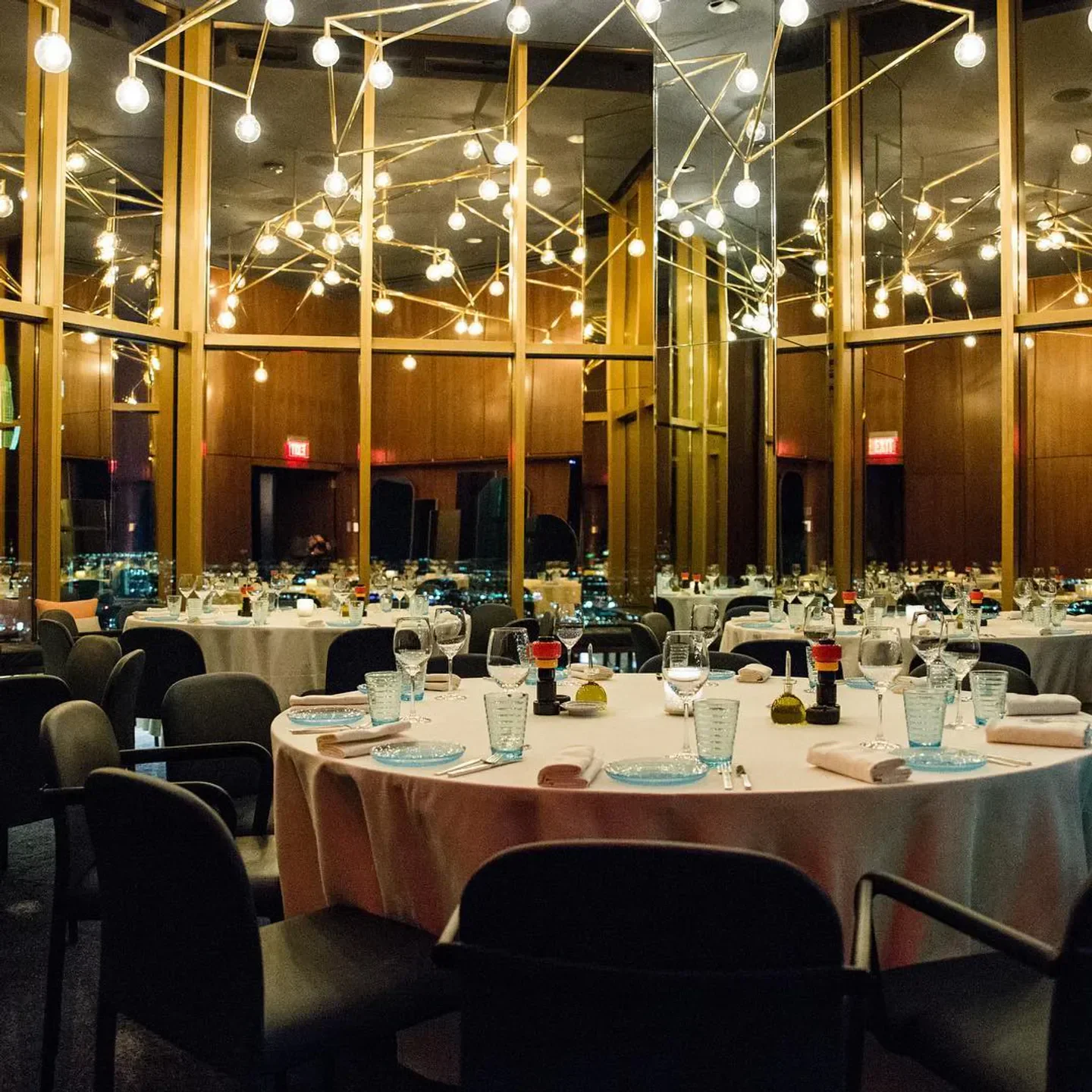 Elegant dining room interior at Rivea restaurant in Las Vegas, with city views.