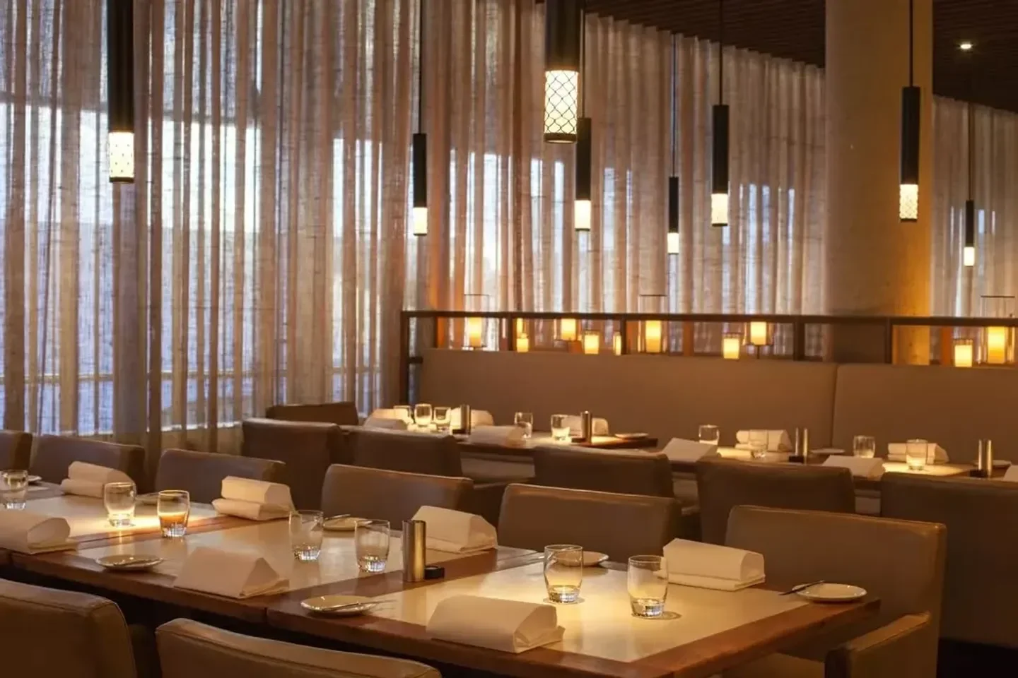 Elegant dining room interior at Rockpool Bar and Grill in Sydney, with ambient lighting.