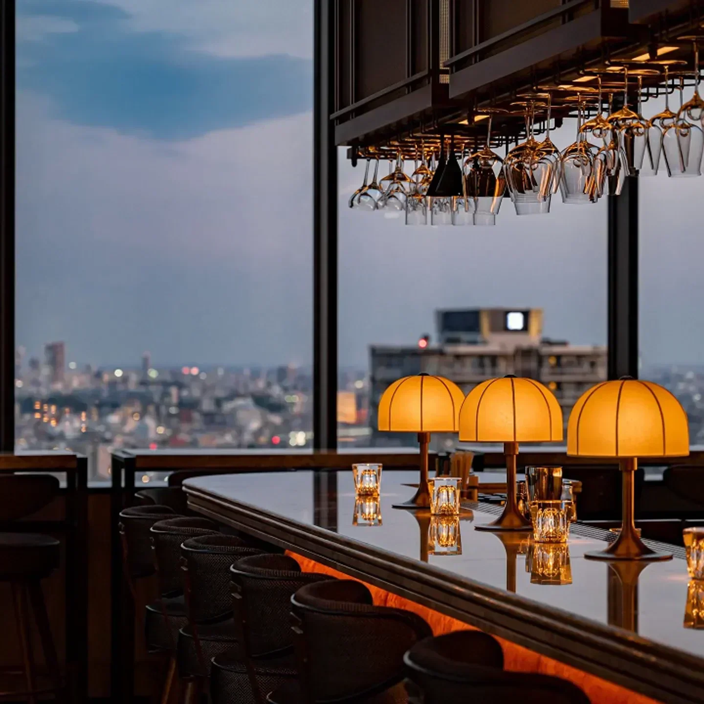 Rooftop Bar 86 in Tokyo, with panoramic city views and stylish bar interior at dusk.