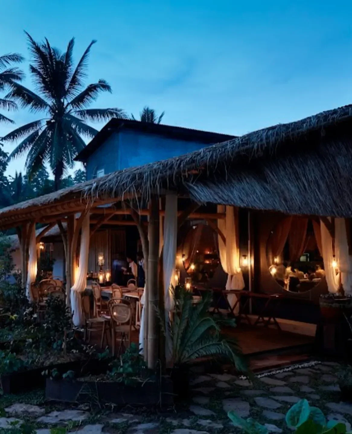 Room 4 Dessert in Bali: cozy, tropical dining space with warm lighting and palm trees.