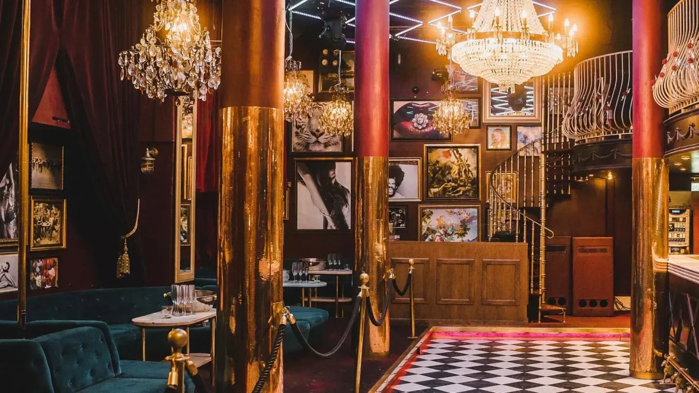 Glamorous interior of Rose Club in Stockholm, featuring chandeliers and a stylish dance floor.