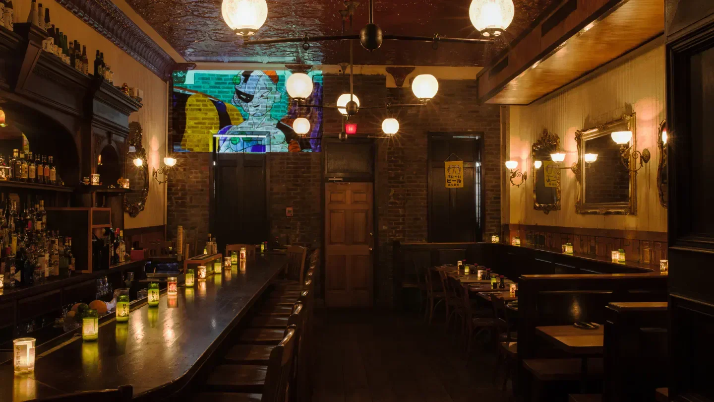 Cozy interior of Royal Sushi & Izakaya in Philadelphia, featuring bar and seating areas.