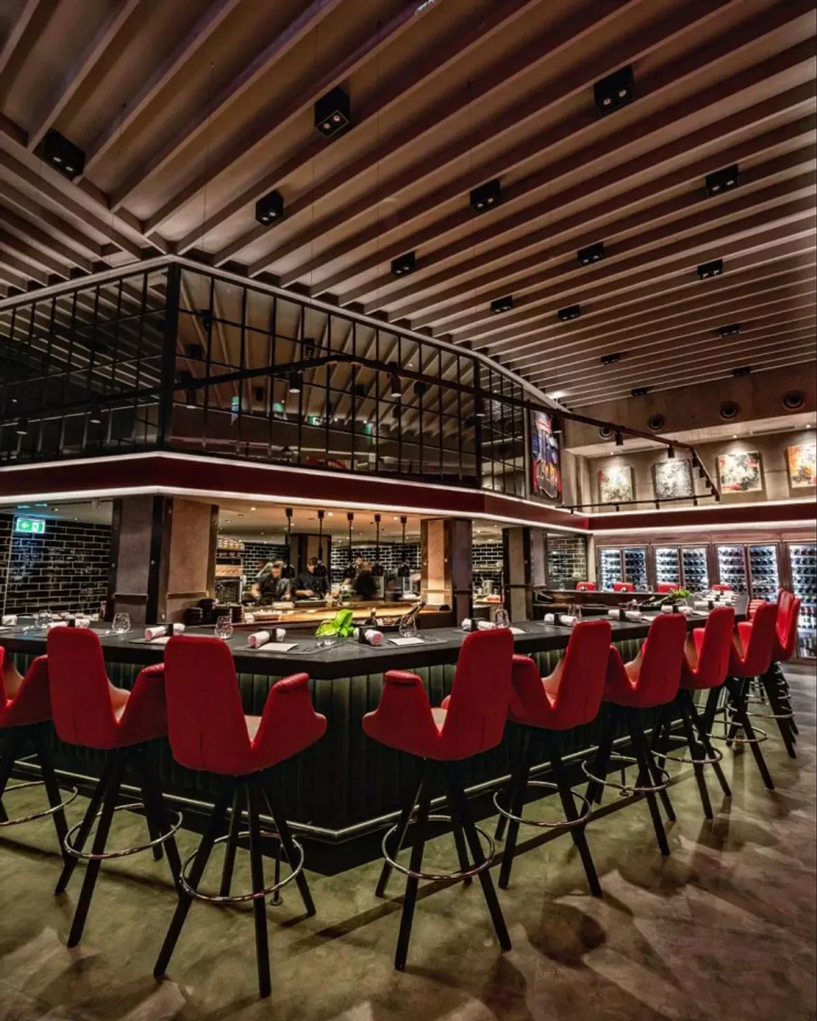 Stylish bar and red chairs inside Rumour restaurant in Budapest.