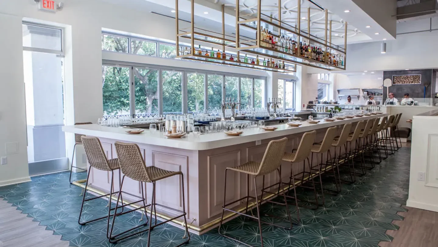 Stylish bar area inside Sachet restaurant in Dallas, with modern design and decor.