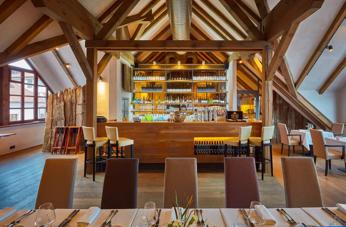 Interior of Salabka restaurant in Prague, featuring a bar and elegant dining area.
