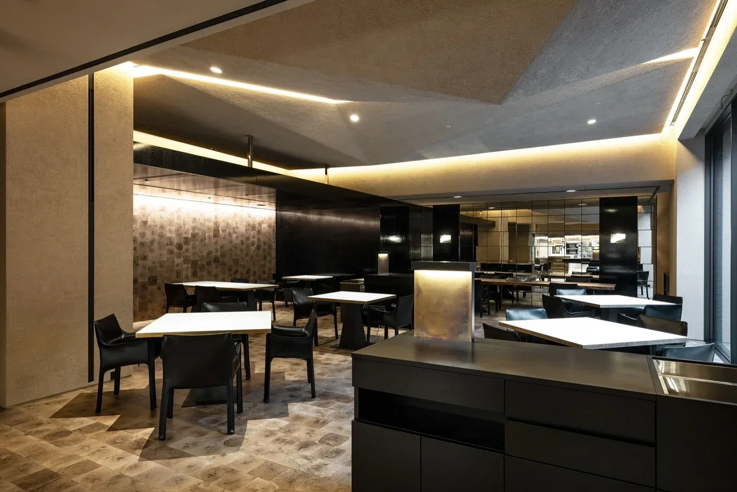 San restaurant interior in South Korea features modern dining tables and elegant black chairs with ambient lighting.