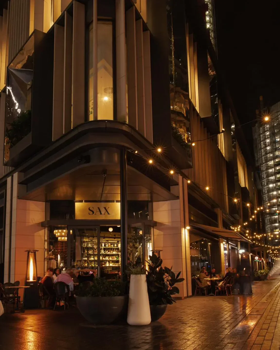 Sax Café & Lounge Bar in Sydney at night, outdoor dining and glowing lights.