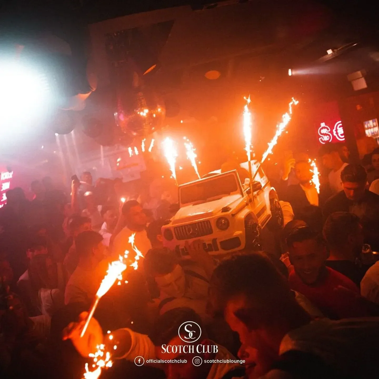 Scotch Club Vienna: lively nightclub scene with sparklers and a model car