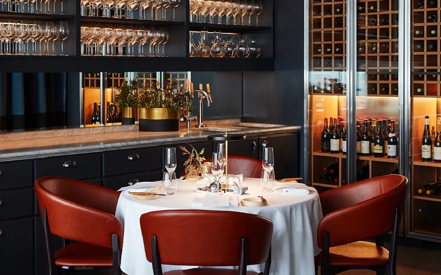 Interior of Seafood Gastro in Stockholm, featuring elegant table setting and wine cellar.