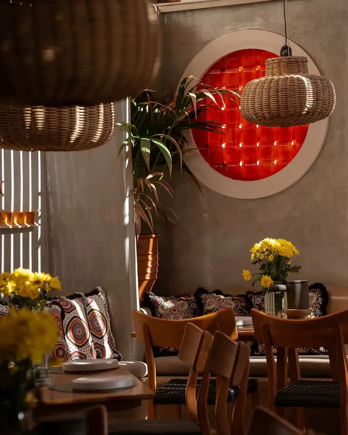 Cozy dining area at Seaside restaurant in Santorini with stylish decor and flowers
