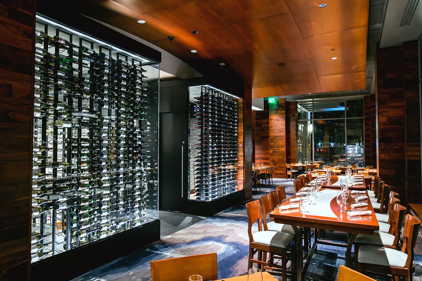 Interior of Seastar Restaurant & Raw Bar in Seattle, featuring wine displays and dining tables.
