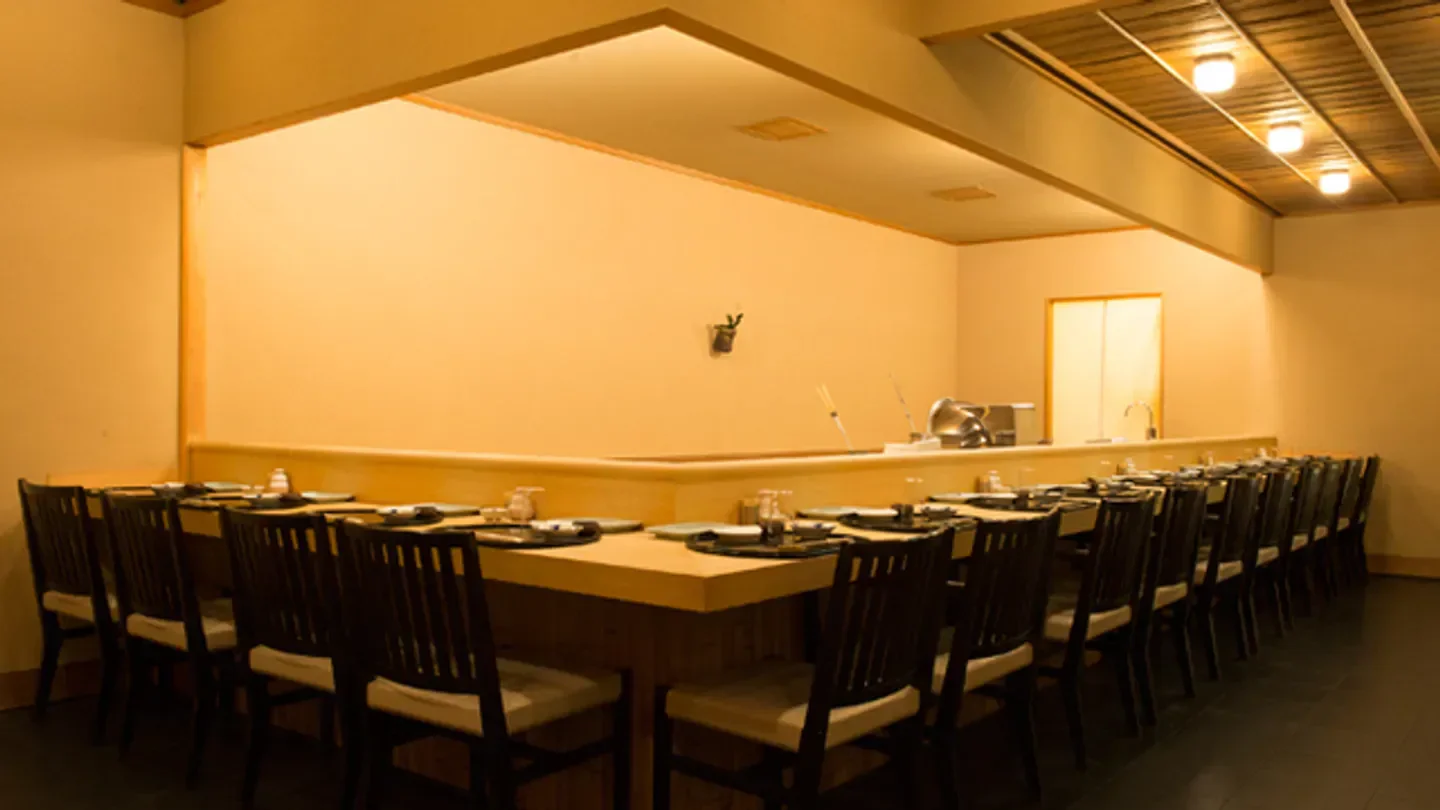 Interior of Seiju restaurant in Tokyo, showcasing a minimalist dining space and wooden tables.