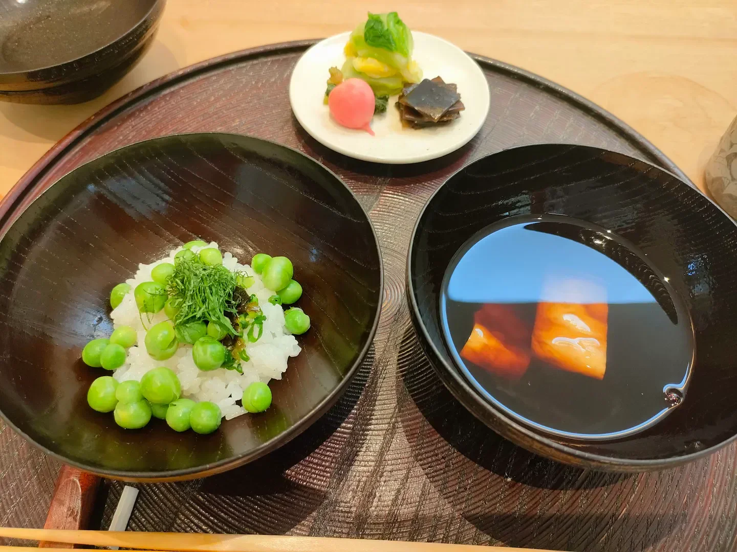 Delicious pea rice dish at Seisoka restaurant in Tokyo, served with clear broth and appetizers.