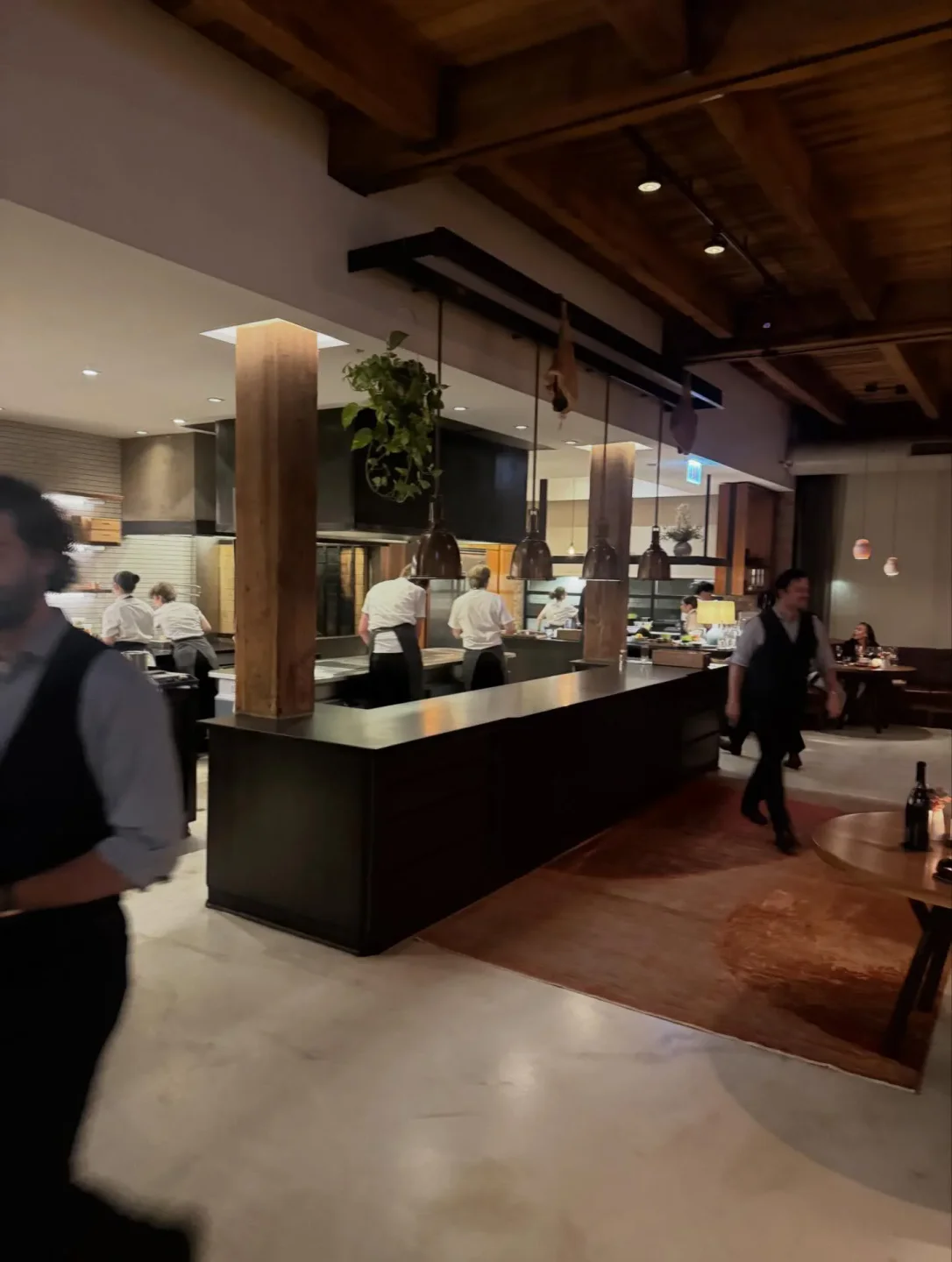 Seline restaurant's modern open kitchen with chefs working and ambient dining area in the city.