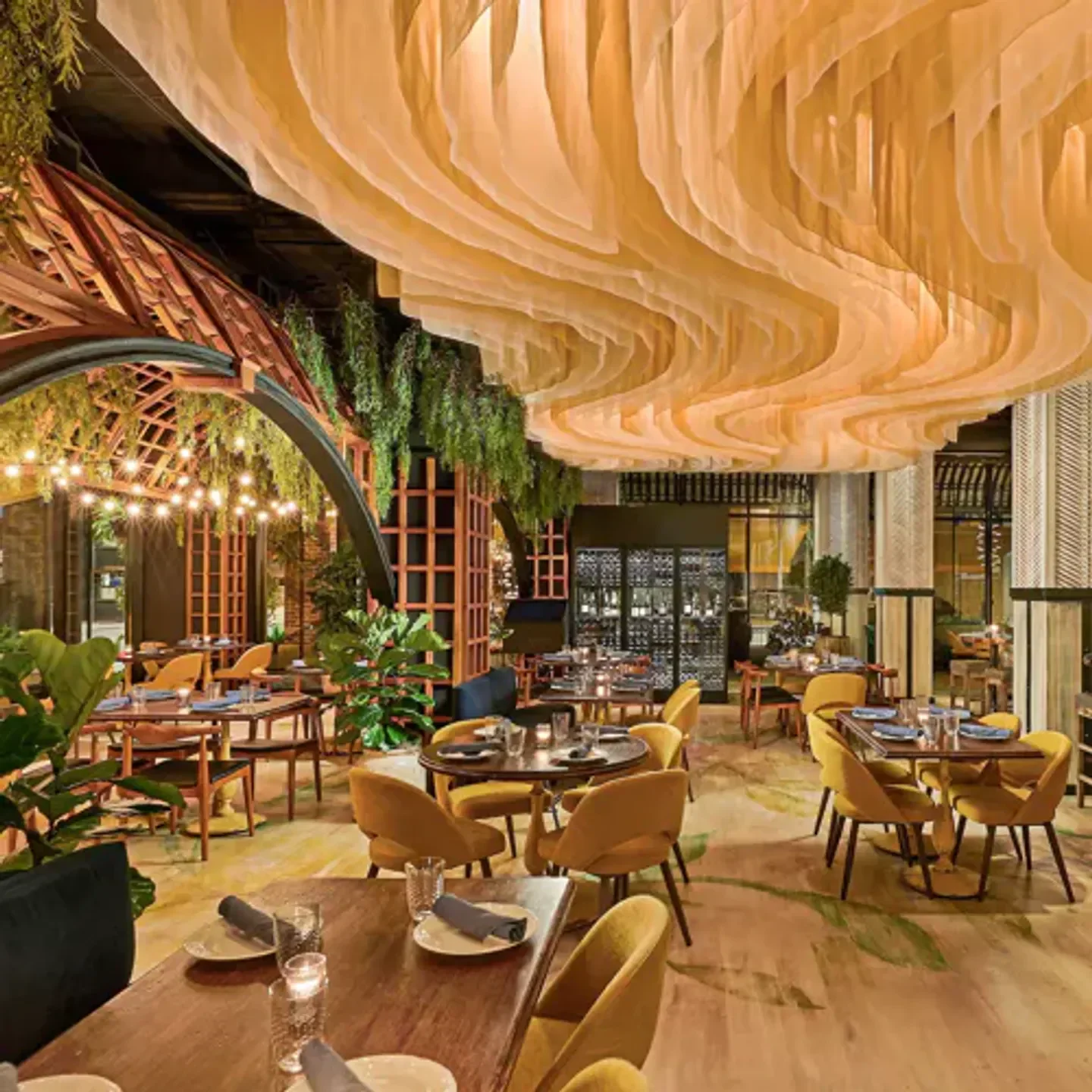 Interior of Sepia restaurant in Chicago with decorative ceiling and dining area.