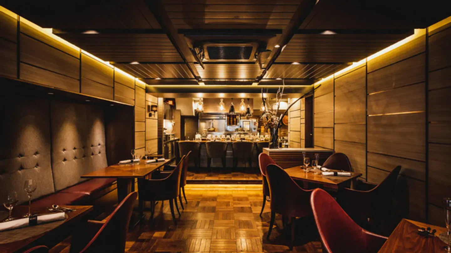 Cozy interior of Series restaurant in Tokyo, featuring warm lighting and elegant dining spaces