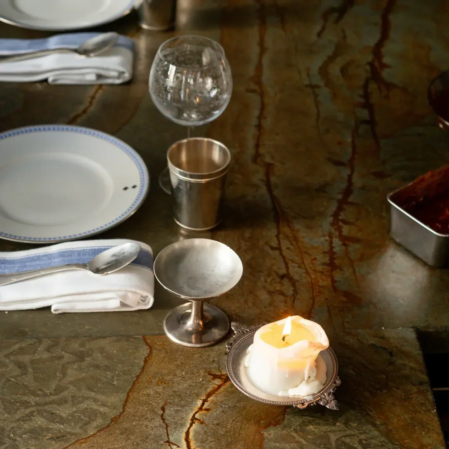 Table setting at Shabour restaurant in Paris: candle, plates, glasses and silverware