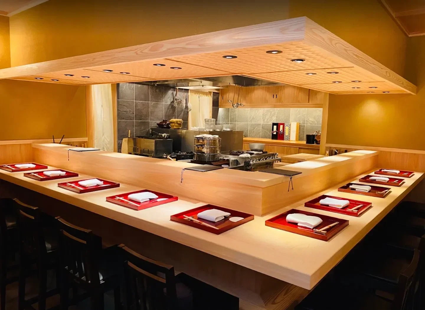 Interior of Sharikimon Onozawa restaurant in Tokyo, with sushi plates set on the counter.