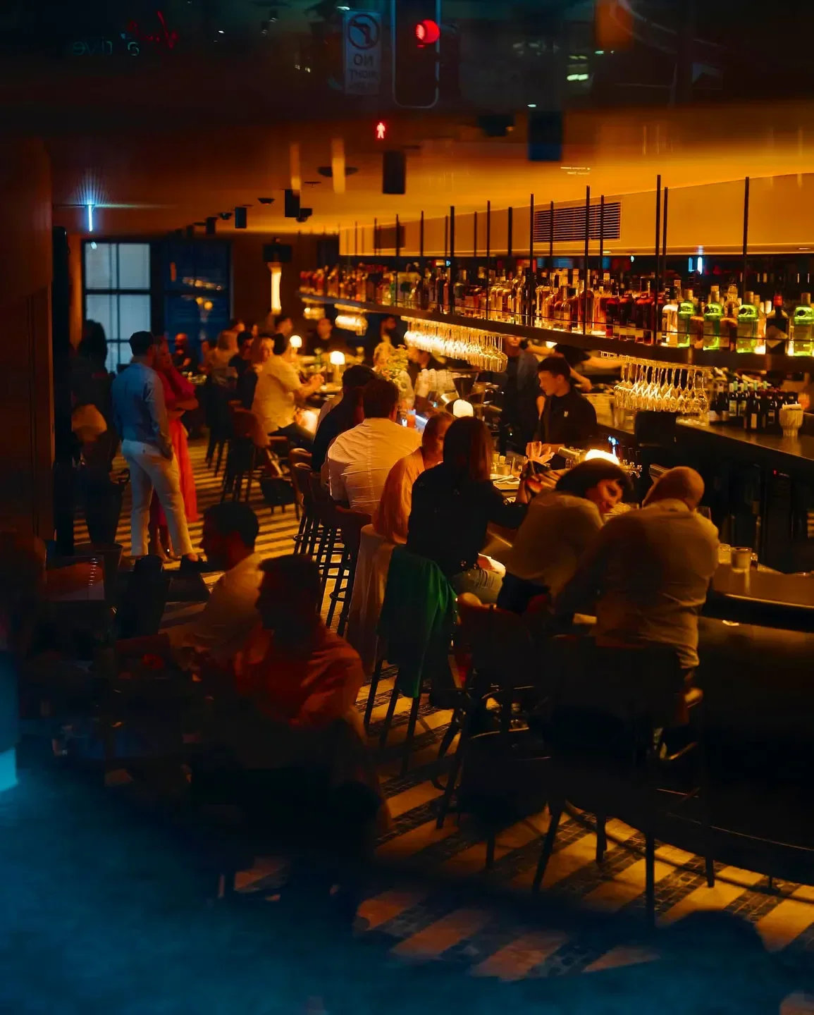 Busy bar at Shell House The Dining Room & Terrace, Sydney, with a warm, inviting atmosphere.