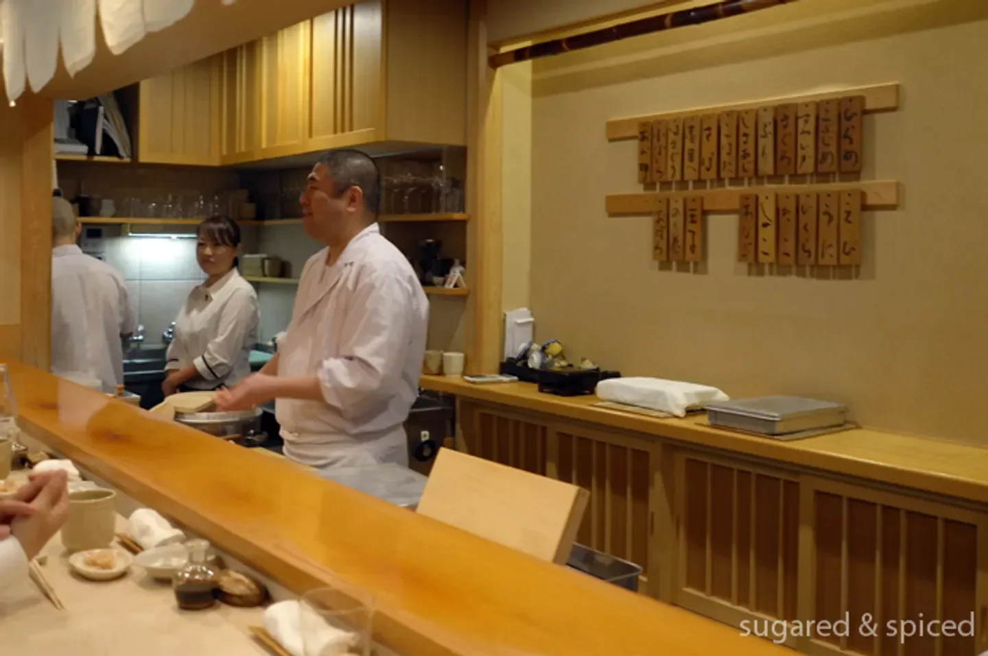 Chef at Shinbashi Shimizu in Tokyo preparing food at the restaurant's sushi counter.